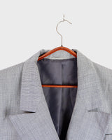 Give your wardrobe an edge with this grey spring double row buttons blazer from the 80s! With subtle yet stylish shoulder pads and a thin design, this blazer will add a touch of timeless vintage charm to any outfit.
