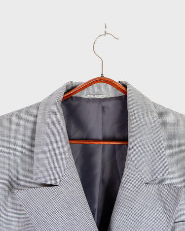 Give your wardrobe an edge with this grey spring double row buttons blazer from the 80s! With subtle yet stylish shoulder pads and a thin design, this blazer will add a touch of timeless vintage charm to any outfit.