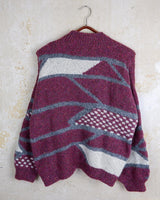 Add a pop of pink to your wardrobe with our vintage 80s wool sweater, featuring a geometric pattern.