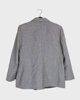 Give your wardrobe an edge with this grey spring double row buttons blazer from the 80s! With subtle yet stylish shoulder pads and a thin design, this blazer will add a touch of timeless vintage charm to any outfit.