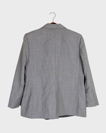 Give your wardrobe an edge with this grey spring double row buttons blazer from the 80s! With subtle yet stylish shoulder pads and a thin design, this blazer will add a touch of timeless vintage charm to any outfit.