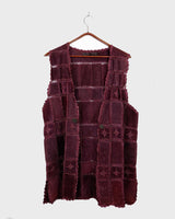 This burgundy leather vest is a vintage gem from the 80s, featuring unique stitching flowers and a boho-style cut. With no closure, it's perfect for layering over any outfit!