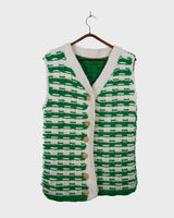 This handmade knit vest in rich green and cream tones is a true eye-catcher. Crafted from wool blend yarn and finished with natural wooden buttons, it blends cozy texture with bold design. The chunky crochet style and timeless check pattern make it perfect for layering.