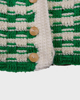 This handmade knit vest in rich green and cream tones is a true eye-catcher. Crafted from wool blend yarn and finished with natural wooden buttons, it blends cozy texture with bold design. The chunky crochet style and timeless check pattern make it perfect for layering.