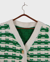 This handmade knit vest in rich green and cream tones is a true eye-catcher. Crafted from wool blend yarn and finished with natural wooden buttons, it blends cozy texture with bold design. The chunky crochet style and timeless check pattern make it perfect for layering.