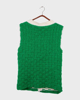 This handmade knit vest in rich green and cream tones is a true eye-catcher. Crafted from wool blend yarn and finished with natural wooden buttons, it blends cozy texture with bold design. The chunky crochet style and timeless check pattern make it perfect for layering.