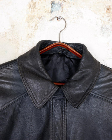 Introducing this Vintage 80s black fireman clasp leather coat, a must-have piece for your collection. Made of buttery soft leather, this coat exudes a cool and edgy vibe.