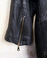 Introducing this Vintage 80s black fireman clasp leather coat, a must-have piece for your collection. Made of buttery soft leather, this coat exudes a cool and edgy vibe.
