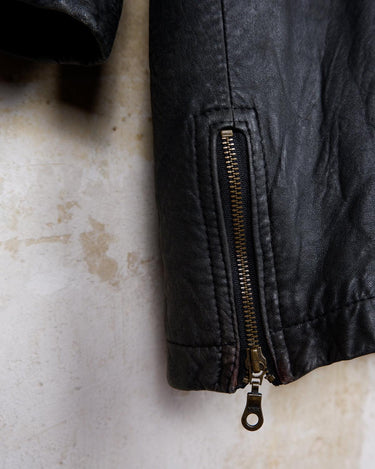 Introducing this Vintage 80s black fireman clasp leather coat, a must-have piece for your collection. Made of buttery soft leather, this coat exudes a cool and edgy vibe.