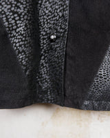 This vintage black leather coat blends matte suede leather with subtly glossy smooth leather panels in rich black tones. The unique patchwork design, featuring delicate dot-textured sections, adds depth, texture, and quiet individuality. With its sleek cut, button front, and spacious pockets, this timeless piece is full of character – perfect for those who appreciate quality and one-of-a-kind style.
