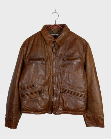 Fall in love with this italian vintage 80s brown leather jacket! With its classic look, warm wool lining, and thick leather material, you'll look and feel great while staying cozy!