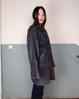 Introducing this Vintage 80s black fireman clasp leather coat, a must-have piece for your collection. Made of buttery soft leather, this coat exudes a cool and edgy vibe.