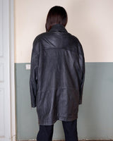 Introducing this Vintage 80s black fireman clasp leather coat, a must-have piece for your collection. Made of buttery soft leather, this coat exudes a cool and edgy vibe.