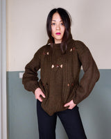 This Vintage 90s brown wool sweater is sure to make a statement with its unique cut outs. Made from high-quality wool, it's perfect for staying cozy while still showing off some skin.