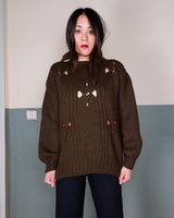 This Vintage 90s brown wool sweater is sure to make a statement with its unique cut outs. Made from high-quality wool, it's perfect for staying cozy while still showing off some skin.