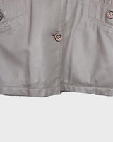 This grey spring coat combines vintage vibes with shoulder pads for a touch of 80s flair.