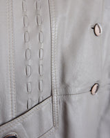 This grey spring coat combines vintage vibes with shoulder pads for a touch of 80s flair.