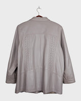 This grey spring coat combines vintage vibes with shoulder pads for a touch of 80s flair.
