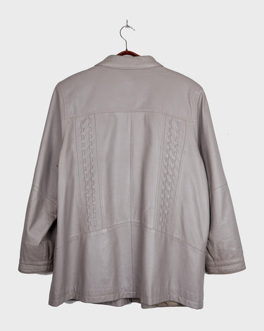 This grey spring coat combines vintage vibes with shoulder pads for a touch of 80s flair.