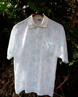 Sun’s out, button up! This Italian vintage white polo shirt brings serious 80s energy with its sharp button-up neckline and eye-catching turquoise pattern. A rare vintage gem that’s equal parts sporty, stylish, and a little cheeky. Wear it loud, wear it proud – this polo’s got main character energy.