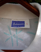 Sun’s out, button up! This Italian vintage white polo shirt brings serious 80s energy with its sharp button-up neckline and eye-catching turquoise pattern. A rare vintage gem that’s equal parts sporty, stylish, and a little cheeky. Wear it loud, wear it proud – this polo’s got main character energy.