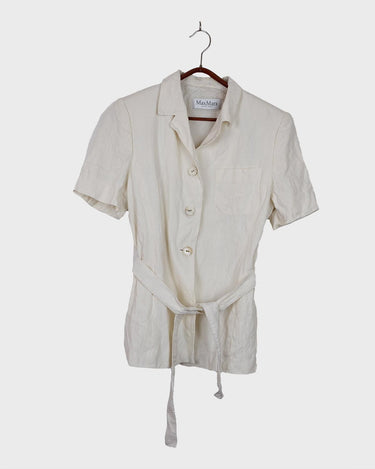 Slip into effortless luxury with this vintage Max Mara pure linen blouse — straight from the golden age of 90s Italian fashion. With its sharp lapels, sculpted silhouette, and waist-defining belt, it’s pure understated power dressing. Made from 100% premium linen, it’s light, luxe, and built for those sun-drenched days. Vintage Max Mara never goes out of style.