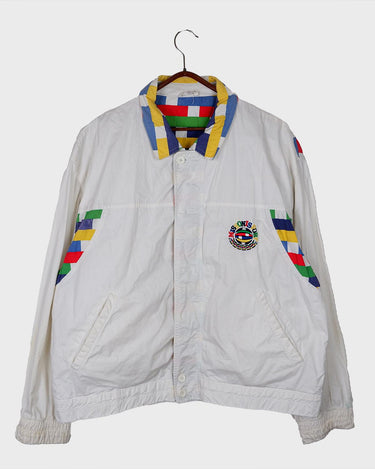 This vintage Missoni Sport windbreaker from the 90s is a standout piece with its bold striped accents and iconic globe logo embroidery. Made in Italy and cut in a comfortable size L, it offers a relaxed fit and lightweight feel – ideal for everyday wear. A rare example of Missoni’s sporty aesthetic, combining timeless design with a splash of color. Effortlessly cool and easy to style.