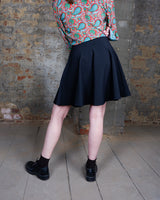 This vintage 90s mini skirt with bold gold ring details is a true statement piece with attitude. Vintage, but made for now.
