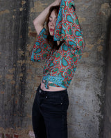 Inspired by the free-spirited vibe of the 70s, this boho paisley-patterned silk-blend tie crop-fit blouse features flared sleeves and a breezy silhouette. Lightweight, very thin, colorful and perfect for sizes XS to S. Throw it on, tie it up, and let your outfit do the talking.