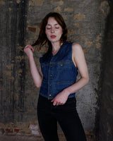 This vintage denim vest is tough, timeless, and ready to layer. It features classic brass snap buttons and four front pockets for that old-school workwear vibe.