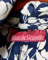 Get ready to channel some serious 90s romance with this vintage navy blue floral blouse with its light shimmering optic. Crafted from a luxurious silk mix blend, it features golden buttons and a unique collar for some extra flair. Romance never goes out of style!