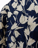 Get ready to channel some serious 90s romance with this vintage navy blue floral blouse with its light shimmering optic. Crafted from a luxurious silk mix blend, it features golden buttons and a unique collar for some extra flair. Romance never goes out of style!