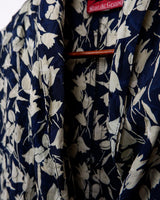Get ready to channel some serious 90s romance with this vintage navy blue floral blouse with its light shimmering optic. Crafted from a luxurious silk mix blend, it features golden buttons and a unique collar for some extra flair. Romance never goes out of style!