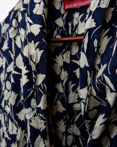 Get ready to channel some serious 90s romance with this vintage navy blue floral blouse with its light shimmering optic. Crafted from a luxurious silk mix blend, it features golden buttons and a unique collar for some extra flair. Romance never goes out of style!