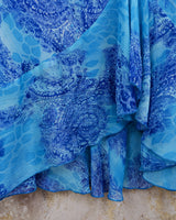 Soft shades of blue and a flowing cut give this 90s maxi dress an easy, fairy-like feel. The asymmetrical hem adds just enough edge to keep it from being too sweet.