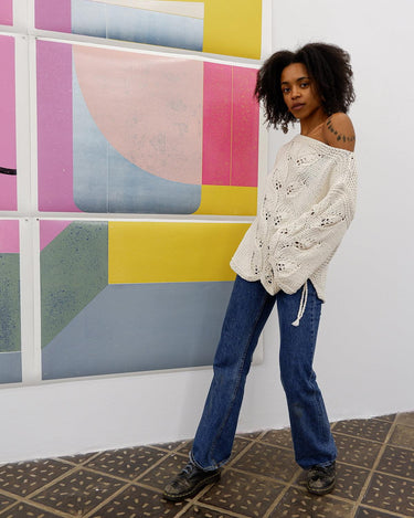 Say goodbye to basic sweaters! This handmade white sweater with dramatic flared sleeves is sure to make a statement. Who needs plain when you've got flair?!