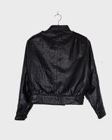 This Vintage 80s black leather jacket is the ultimate classic, complete with press buttons, structured vibes, and smooth leather.