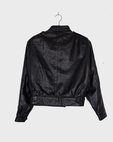 This Vintage 80s black leather jacket is the ultimate classic, complete with press buttons, structured vibes, and smooth leather.