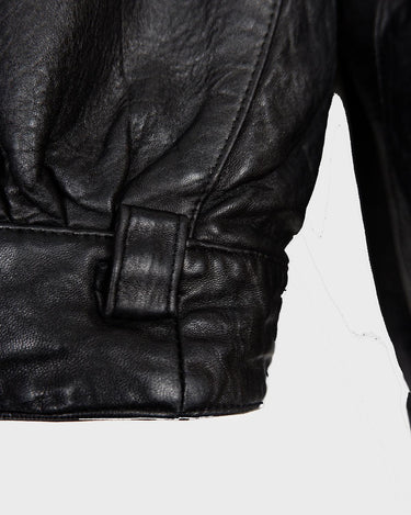 This Vintage 80s black leather jacket is the ultimate classic, complete with press buttons, structured vibes, and smooth leather.