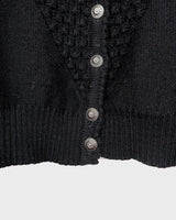 Get cozy with this vintage 80s black traditional cardigan! With its classic design and comfortable fit, this cardigan is perfect for chilly nights.
