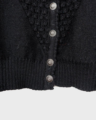 Get cozy with this vintage 80s black traditional cardigan! With its classic design and comfortable fit, this cardigan is perfect for chilly nights.