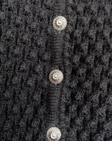 Get cozy with this vintage 80s black traditional cardigan! With its classic design and comfortable fit, this cardigan is perfect for chilly nights.