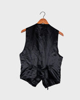 This vintage vest packs the perfect punch of 80s style! With its black velvet material and subtle shimmer of embroidered pailettes, you'll ready to sparkle.