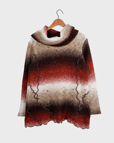 This retro turtleneck takes you on a wild ride of hot reds, cool whites, and mellow browns for a preloved color combo.