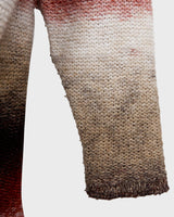 This retro turtleneck takes you on a wild ride of hot reds, cool whites, and mellow browns for a preloved color combo.