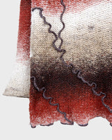 This retro turtleneck takes you on a wild ride of hot reds, cool whites, and mellow browns for a preloved color combo.