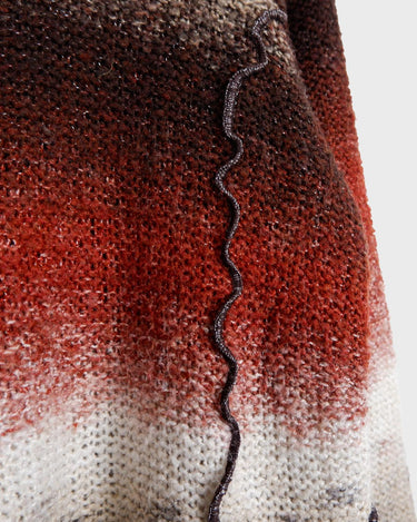 This retro turtleneck takes you on a wild ride of hot reds, cool whites, and mellow browns for a preloved color combo.