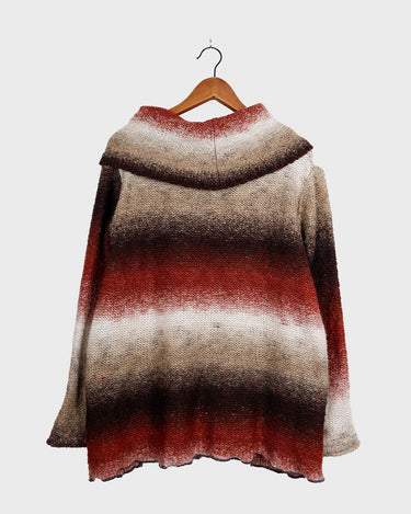 This retro turtleneck takes you on a wild ride of hot reds, cool whites, and mellow browns for a preloved color combo.