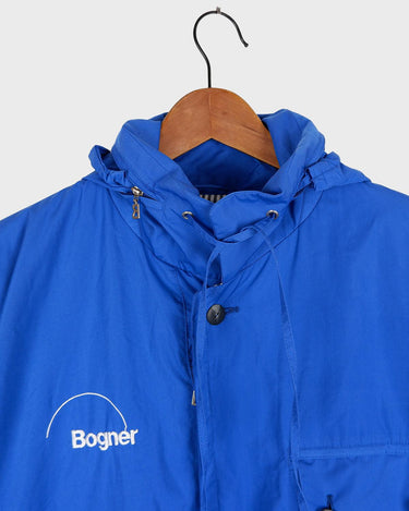 Zip into this Premium Bogner blue hooded jacket (very thin) and make a statement! It's designed with shoulder pads and comes with a hidden hood, so you can always make a quick and effortless transition.