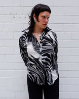 This black and white shirt doesn’t ask for attention — it just gets it. The abstract swirl pattern gives effortless chaos in the best way possible. Throw it on and let the print do the talking!